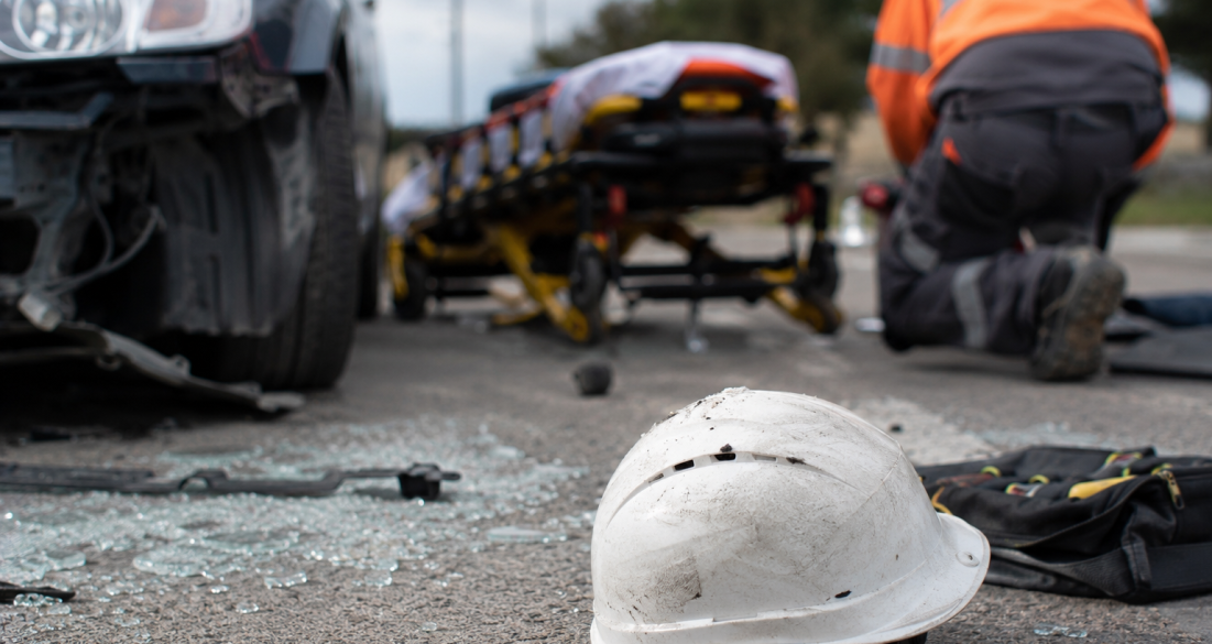 Aftermath of a car crash and workplace injury with emergency response, illustrating traumatic brain injury (TBI) risks.