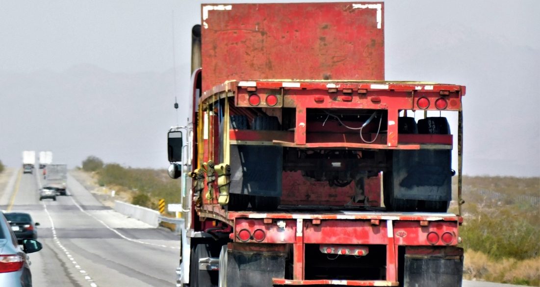 18-wheeler truck carrying a smaller truck
